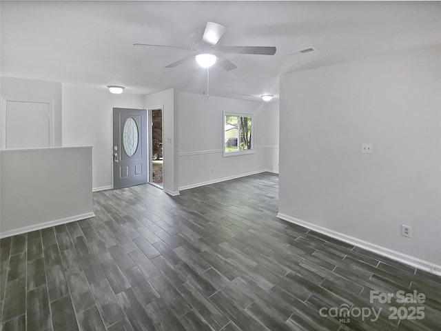 entrance foyer featuring ceiling fan, visible vents, dark wood-style floors, and baseboards