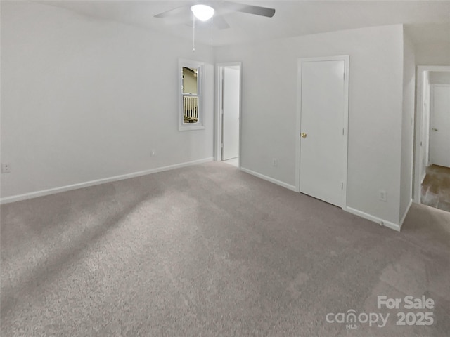 unfurnished bedroom featuring carpet floors, baseboards, and ceiling fan