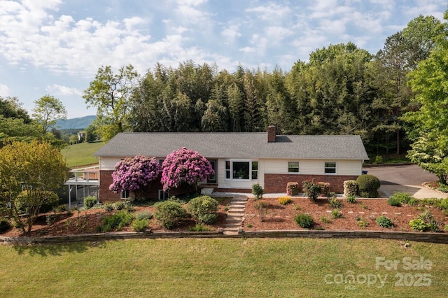 1572 Alexander Rd, Leicester, NC 28748 - ranch-style home with brick siding, a chimney, and a front yard