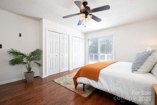 1572 Alexander Rd, Leicester, NC 28748 - bedroom featuring wood finished floors, multiple closets, a ceiling fan, baseboards, and access to exterior
