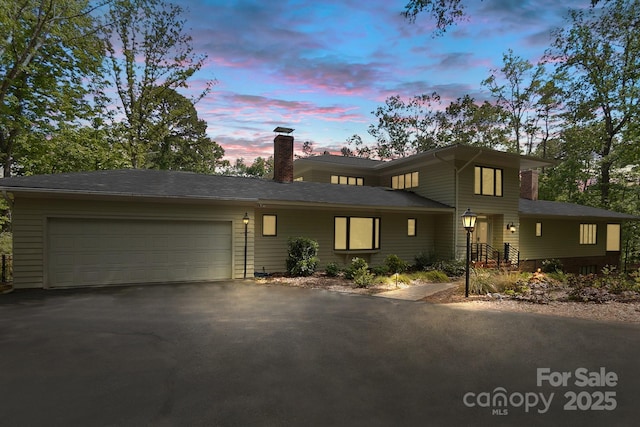 115 Forestcliff Ct NE, Concord, NC 28025 - prairie-style house featuring asphalt driveway, a chimney, and an attached garage