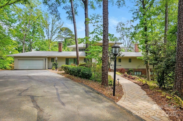 115 Forestcliff Ct NE, Concord, NC 28025 - view of front of property featuring a chimney, asphalt driveway, and an attached garage