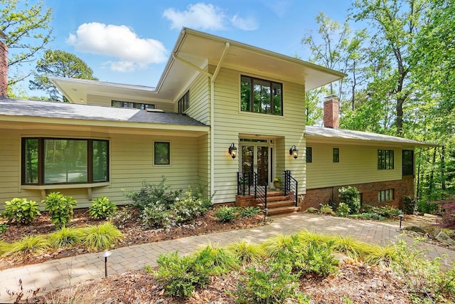 115 Forestcliff Ct NE, Concord, NC 28025 - view of front facade featuring a chimney and french doors