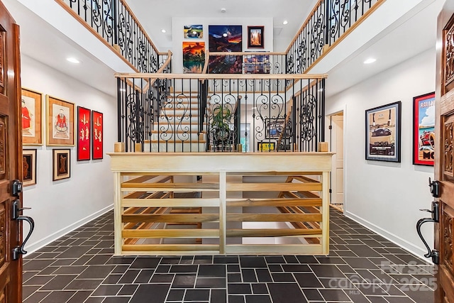 115 Forestcliff Ct NE, Concord, NC 28025 - staircase with baseboards, a towering ceiling, recessed lighting, and tile patterned floors