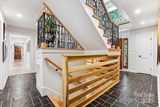 115 Forestcliff Ct NE, Concord, NC 28025 - stairs featuring stone tile flooring, recessed lighting, and baseboards