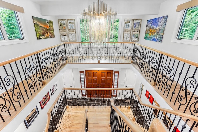 115 Forestcliff Ct NE, Concord, NC 28025 - stairway with plenty of natural light, a chandelier, and wood finished floors