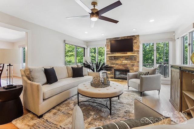 115 Forestcliff Ct NE, Concord, NC 28025 - living room featuring wood finished floors, ceiling fan, a stone fireplace, and recessed lighting