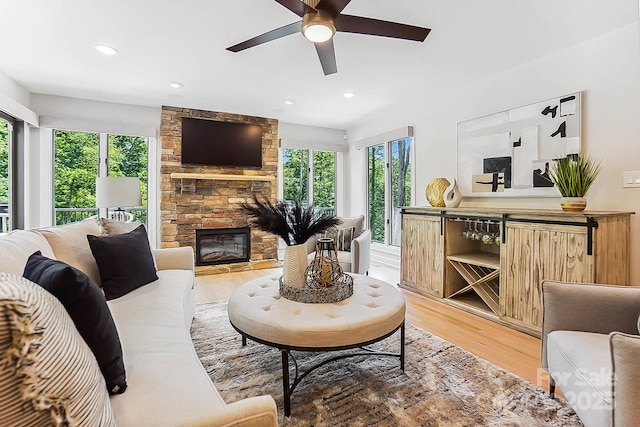 115 Forestcliff Ct NE, Concord, NC 28025 - living room featuring plenty of natural light, light wood-style flooring, a ceiling fan, a fireplace, and recessed lighting