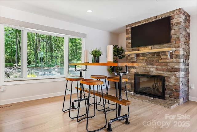 115 Forestcliff Ct NE, Concord, NC 28025 - dining space featuring wood finished floors, baseboards, and a stone fireplace