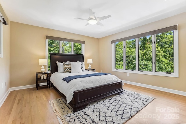 115 Forestcliff Ct NE, Concord, NC 28025 - bedroom featuring multiple windows, baseboards, and light wood finished floors