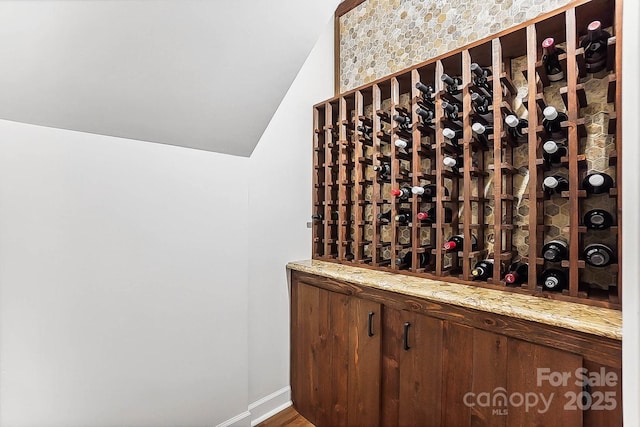 115 Forestcliff Ct NE, Concord, NC 28025 - wine room featuring vaulted ceiling and baseboards