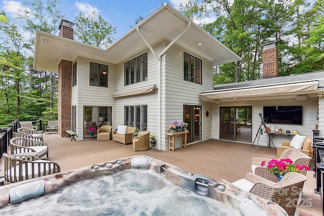 115 Forestcliff Ct NE, Concord, NC 28025 - rear view of property featuring a chimney, a wooden deck, and an outdoor hot tub