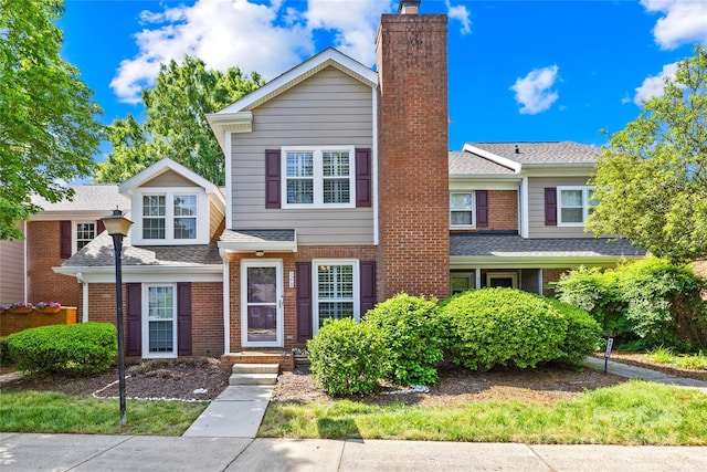 9214 N Vicksburg Park Ct, Charlotte, NC 28210 - view of front of house featuring roof with shingles, a chimney, and brick siding
