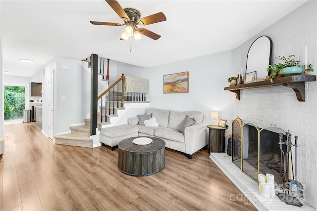 9214 N Vicksburg Park Ct, Charlotte, NC 28210 - living area featuring a fireplace, light wood-style floors, a ceiling fan, baseboards, and stairway