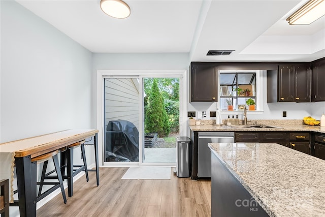 9214 N Vicksburg Park Ct, Charlotte, NC 28210 - kitchen with light stone counters, a sink, light wood-style floors, stainless steel dishwasher, and visible vents