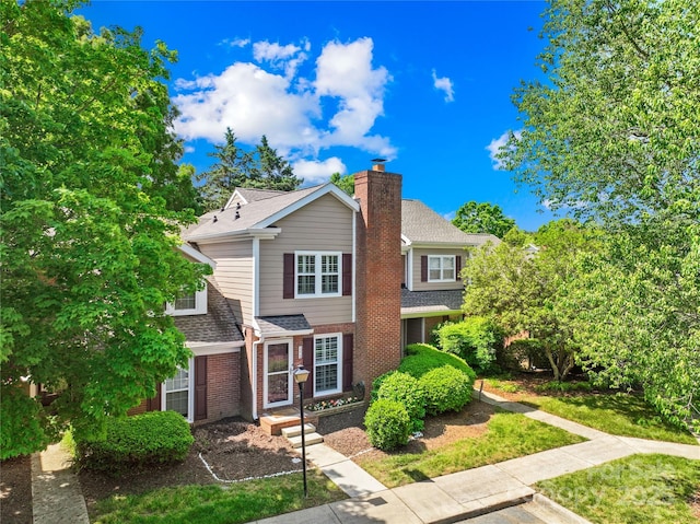 9214 N Vicksburg Park Ct, Charlotte, NC 28210 - traditional home with brick siding, a shingled roof, and a chimney