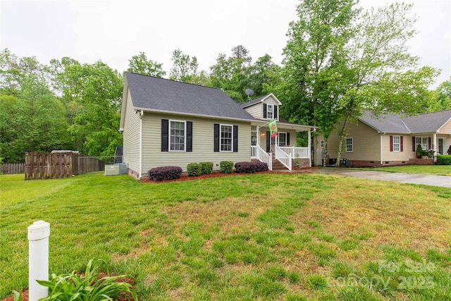 view of front of property with fence, covered porch, a front yard, crawl space, and driveway