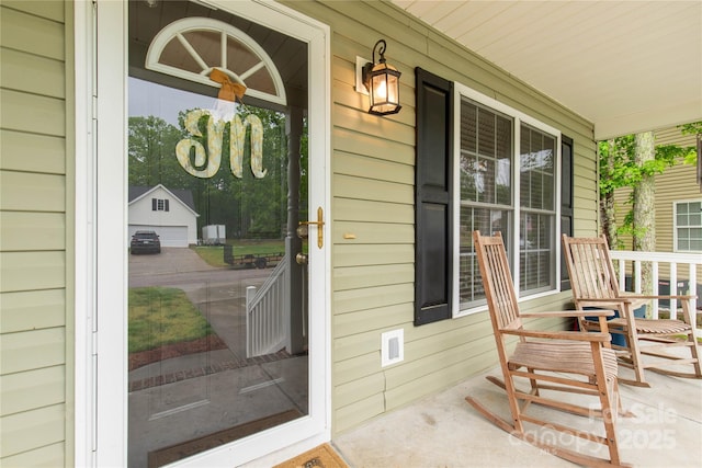 view of exterior entry featuring a porch