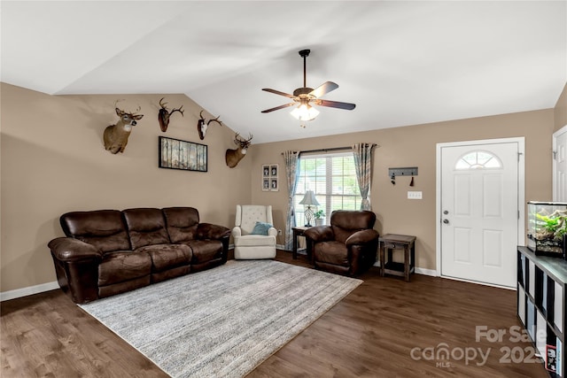 living area featuring dark wood-style flooring, ceiling fan, baseboards, and lofted ceiling