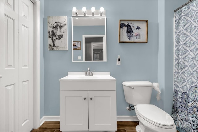 full bath with vanity, baseboards, toilet, and wood finished floors