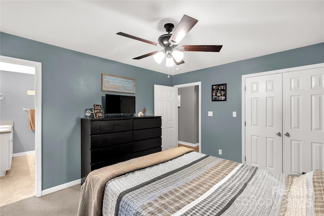 bedroom featuring baseboards, ceiling fan, light carpet, and a closet
