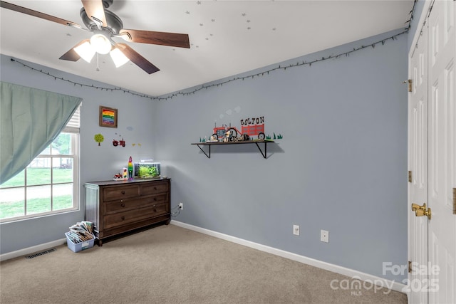 carpeted bedroom featuring baseboards, ceiling fan, a closet, and visible vents
