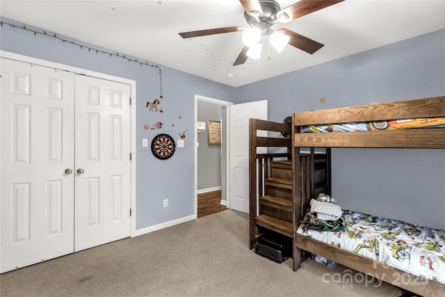 bedroom featuring a closet, baseboards, a ceiling fan, and carpet flooring