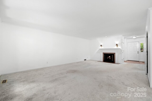 1152 Bent Tree Dr Unit F2Garage, Hendersonville, NC 28739 - unfurnished living room with carpet, a lit fireplace, and baseboards