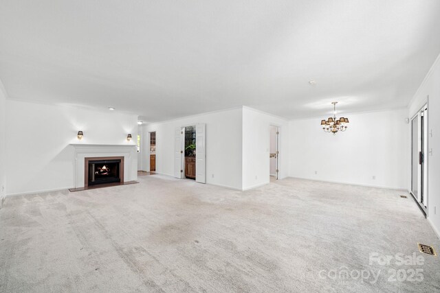 1152 Bent Tree Dr Unit F2Garage, Hendersonville, NC 28739 - unfurnished living room featuring a chandelier, a fireplace with flush hearth, light colored carpet, baseboards, and crown molding