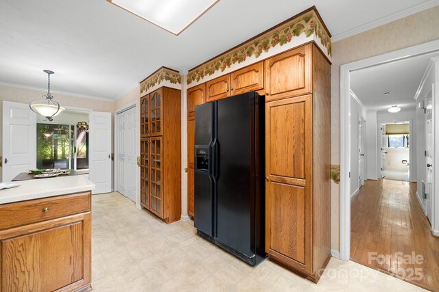 1152 Bent Tree Dr Unit F2Garage, Hendersonville, NC 28739 - kitchen with black fridge with ice dispenser, plenty of natural light, brown cabinets, light countertops, and crown molding