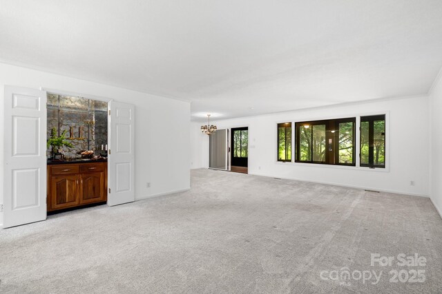 1152 Bent Tree Dr Unit F2Garage, Hendersonville, NC 28739 - empty room with a chandelier, light carpet, and baseboards
