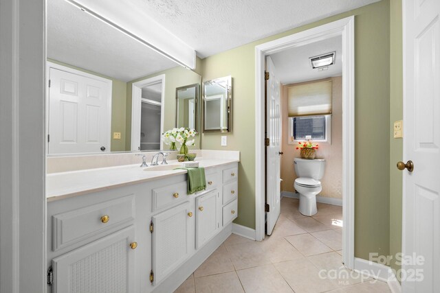 1152 Bent Tree Dr Unit F2Garage, Hendersonville, NC 28739 - full bath featuring tile patterned floors, toilet, vanity, baseboards, and a textured ceiling