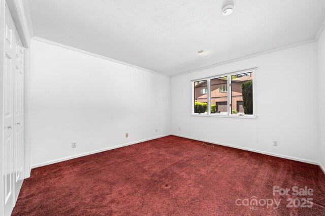 1152 Bent Tree Dr Unit F2Garage, Hendersonville, NC 28739 - empty room featuring crown molding, dark colored carpet, baseboards, and a smoke detector