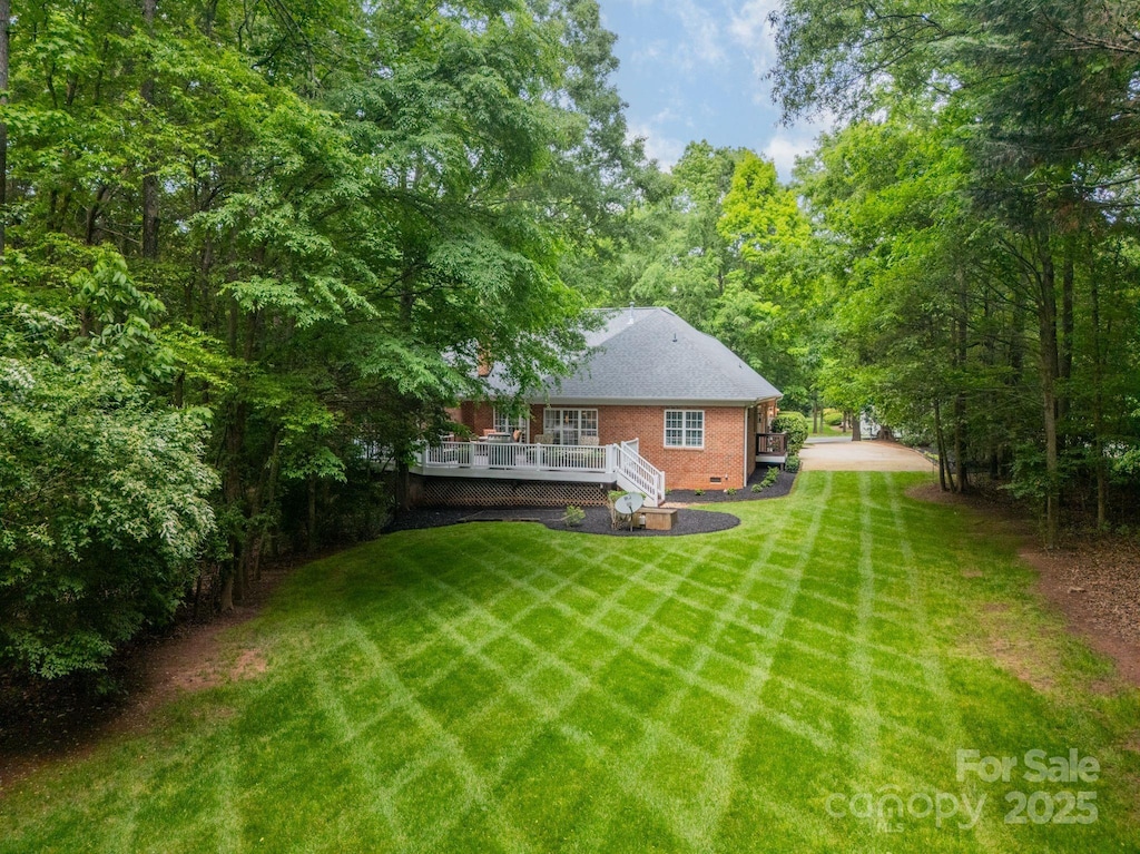 view of yard featuring a wooden deck
