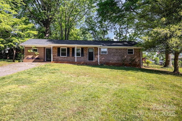 single story home featuring brick siding, crawl space, fence, and a front yard