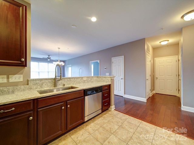 1000 E Woodlawn Rd Unit 402, Charlotte, NC 28209 - kitchen featuring a sink, dishwasher, a peninsula, baseboards, and light tile patterned floors