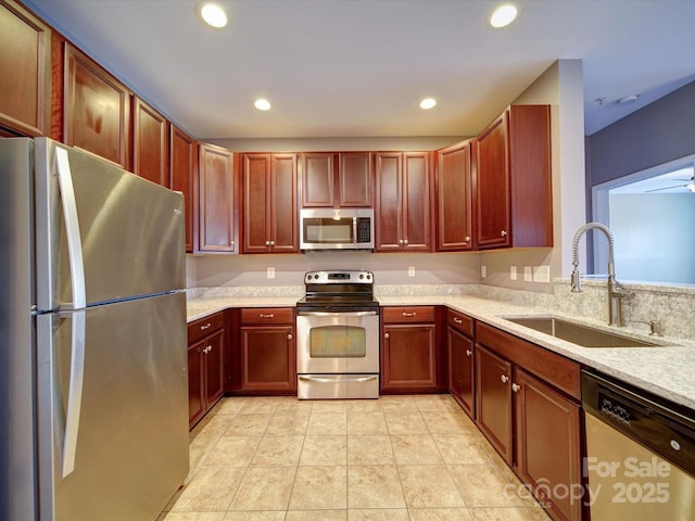 1000 E Woodlawn Rd Unit 402, Charlotte, NC 28209 - kitchen with a sink, stainless steel appliances, recessed lighting, and reddish brown cabinets