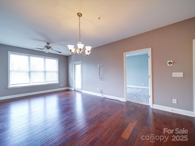 1000 E Woodlawn Rd Unit 402, Charlotte, NC 28209 - empty room featuring baseboards, dark wood finished floors, and ceiling fan with notable chandelier
