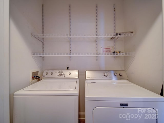 1000 E Woodlawn Rd Unit 402, Charlotte, NC 28209 - clothes washing area featuring separate washer and dryer and laundry area