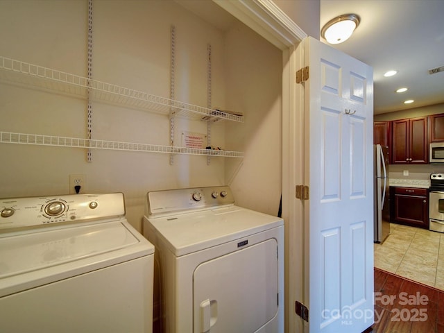 1000 E Woodlawn Rd Unit 402, Charlotte, NC 28209 - laundry room with laundry area, recessed lighting, light wood-type flooring, visible vents, and washer and clothes dryer