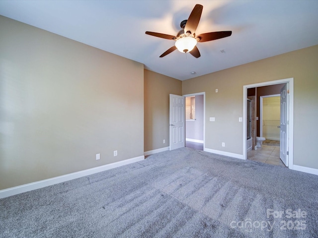 1000 E Woodlawn Rd Unit 402, Charlotte, NC 28209 - unfurnished bedroom featuring baseboards, carpet flooring, ensuite bathroom, and a ceiling fan