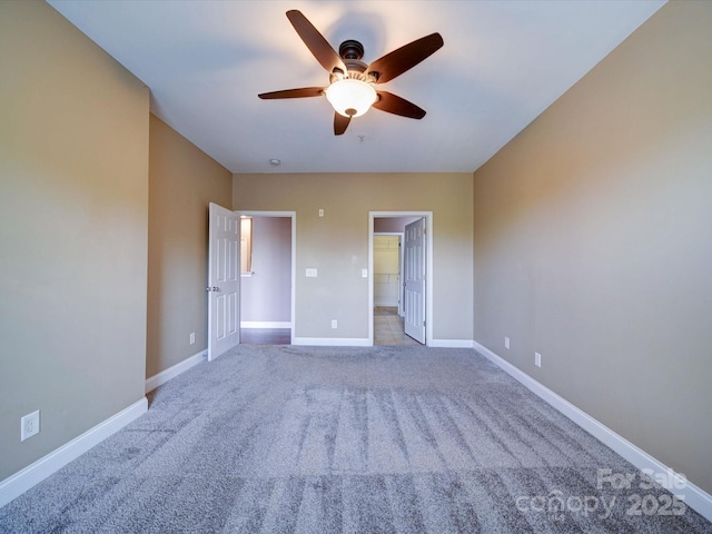 1000 E Woodlawn Rd Unit 402, Charlotte, NC 28209 - unfurnished bedroom featuring carpet floors, baseboards, ceiling fan, and a spacious closet