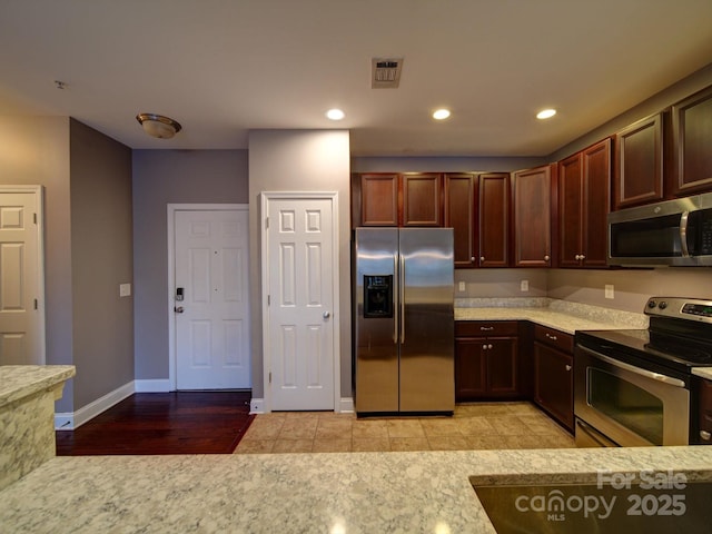1000 E Woodlawn Rd Unit 402, Charlotte, NC 28209 - kitchen featuring stainless steel appliances, recessed lighting, and light stone counters