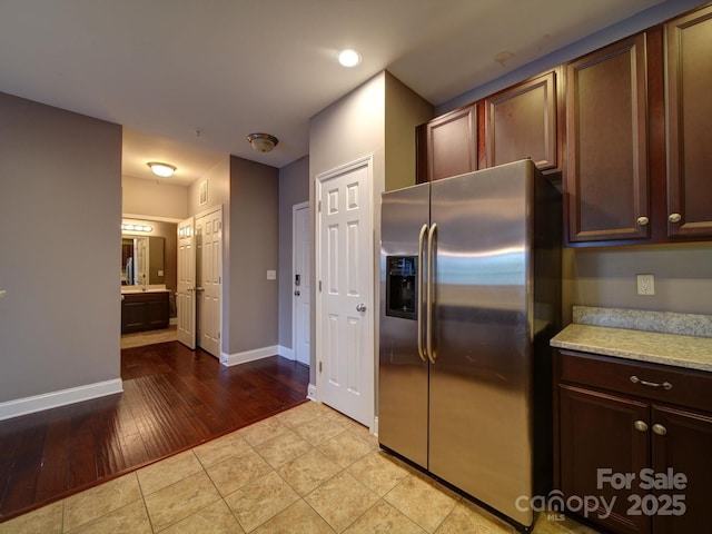 1000 E Woodlawn Rd Unit 402, Charlotte, NC 28209 - kitchen featuring stainless steel fridge, light wood-style floors, recessed lighting, and dark brown cabinetry