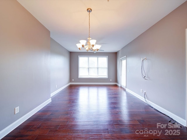 1000 E Woodlawn Rd Unit 402, Charlotte, NC 28209 - spare room featuring a chandelier and dark wood-style floors