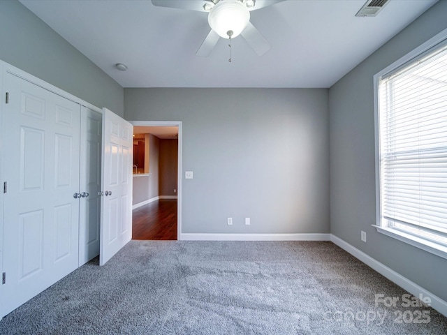 1000 E Woodlawn Rd Unit 402, Charlotte, NC 28209 - unfurnished bedroom with carpet floors, multiple windows, a closet, and a ceiling fan