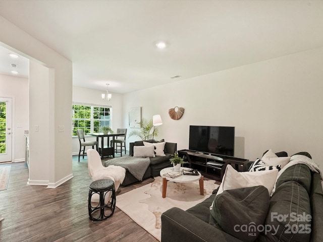 living area featuring baseboards and dark wood-style flooring