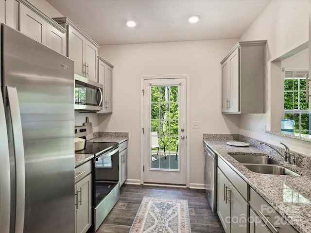 kitchen featuring plenty of natural light, a sink, appliances with stainless steel finishes, and gray cabinetry
