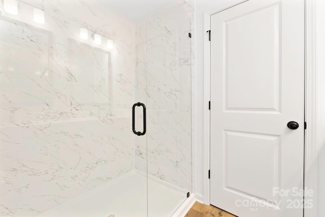 full bath with a shower stall