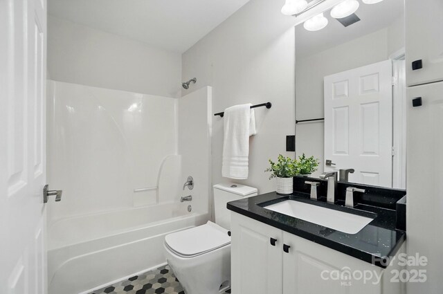 full bathroom featuring vanity, shower / bathing tub combination, tile patterned floors, and toilet